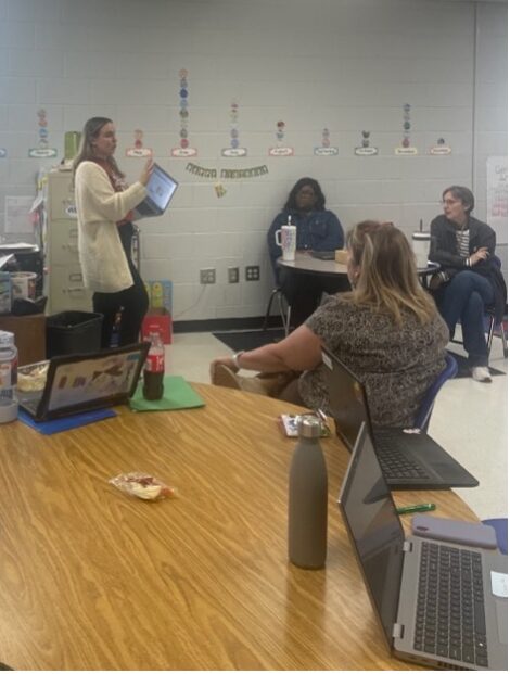 Image of Alison presenting in a classroom. 